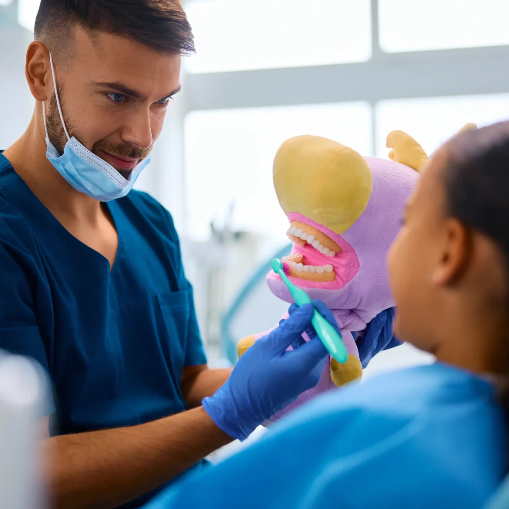 dentist-teaching-black-little-girl-to-brush-teeth-2024-12-13-18-35-40-utc